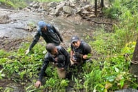 | Photo: PTI : Range forest officers rescue a family